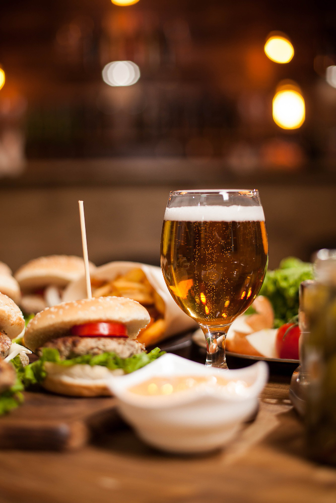 golden-beer-delicious-burgers-wooden-table-french-fries-green-salad-french-fries-garlic-sauce