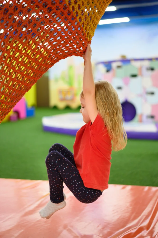 girl-climbing-playground-side-view